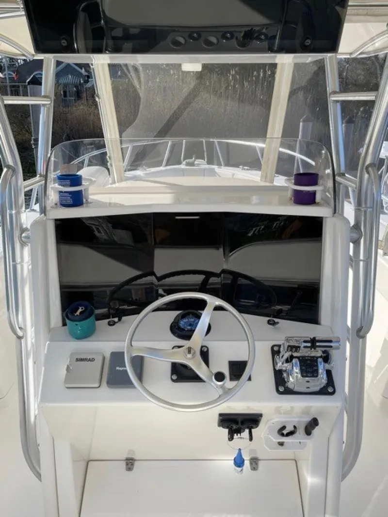 Slide: The Image of 2000 Venture 34 Center Console boat dashboard with steering wheel and controls. - 2