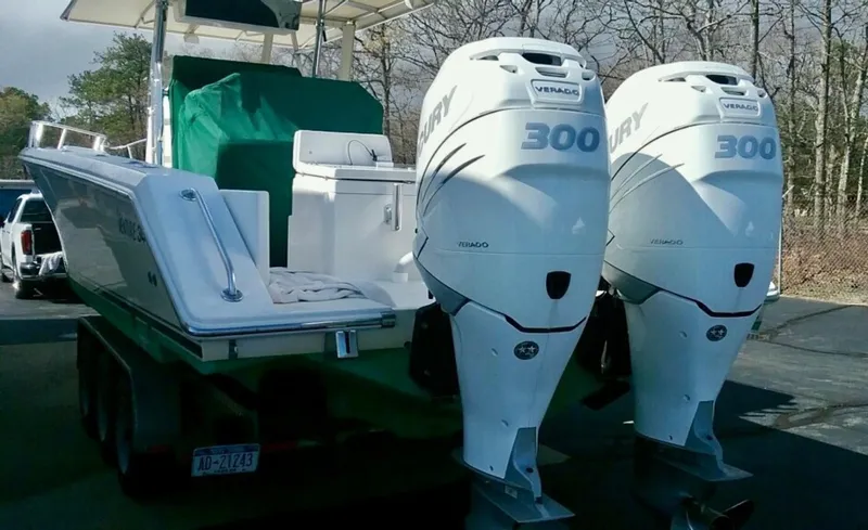 Slide: The Image of 2000 Venture 34 Center Console boat with twin Mercury 300 engines on a trailer. - 20