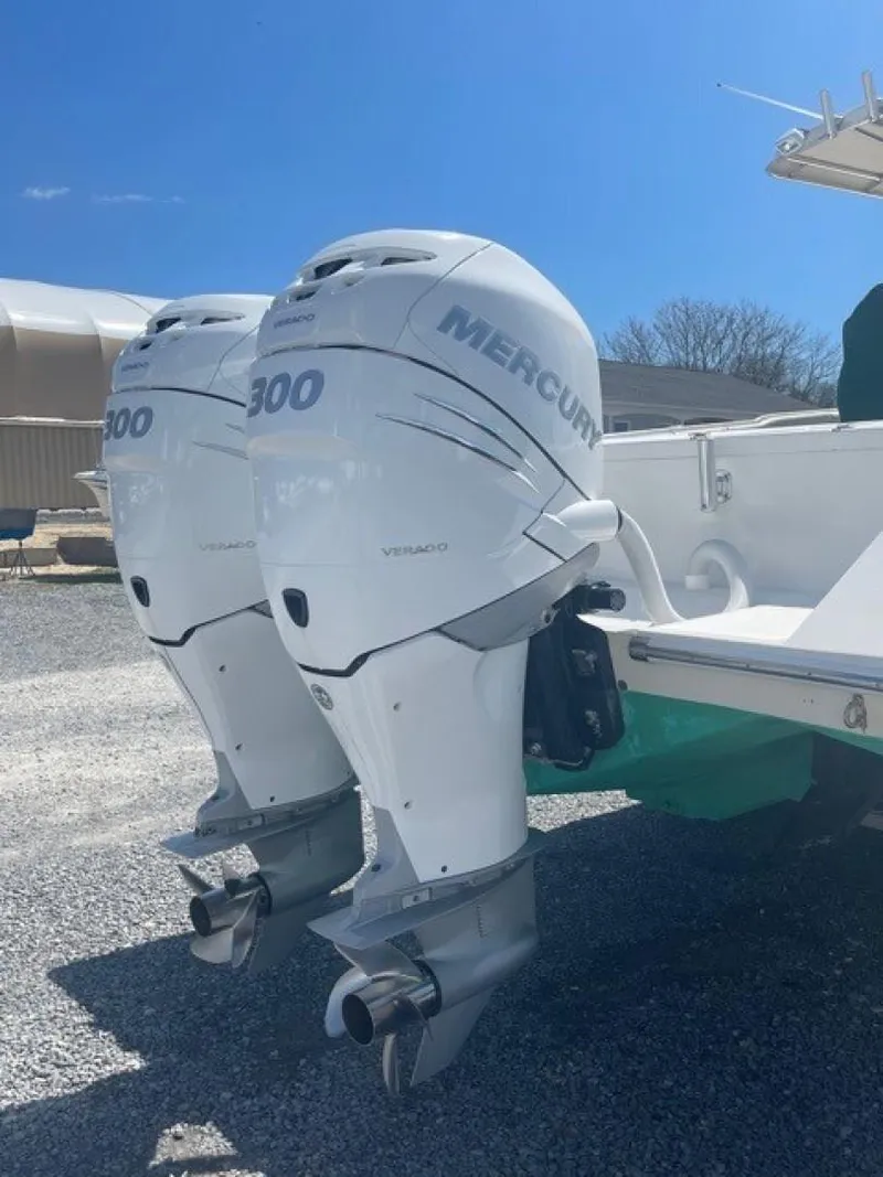 Slide: The Image of Twin Mercury 300 outboard engines on a 2000 Venture 34 Center Console boat. - 21