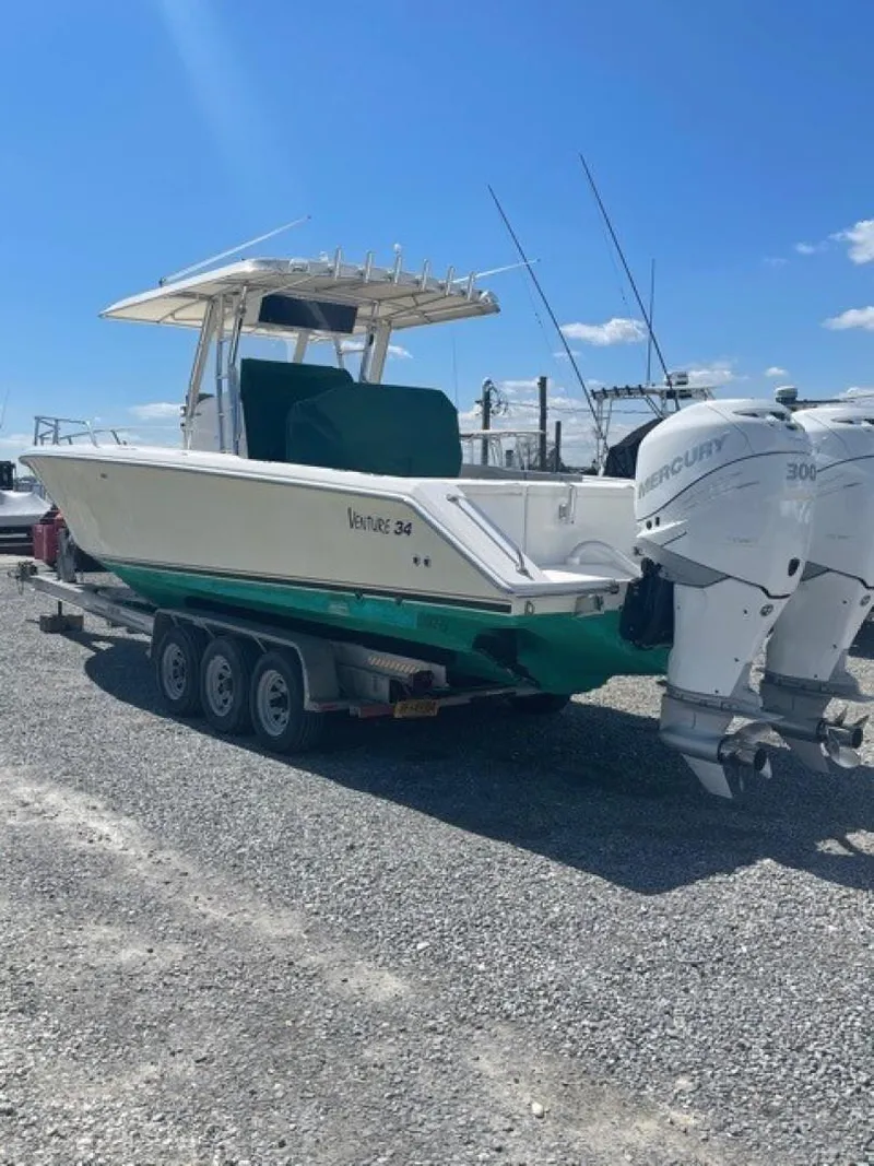 Slide: The Image of 2000 Venture 34 Center Console boat with twin Mercury engines on a trailer. - 24