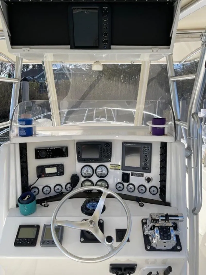 Slide: The Image of Center console of 2000 Venture 34 boat with navigation instruments and steering wheel. - 4