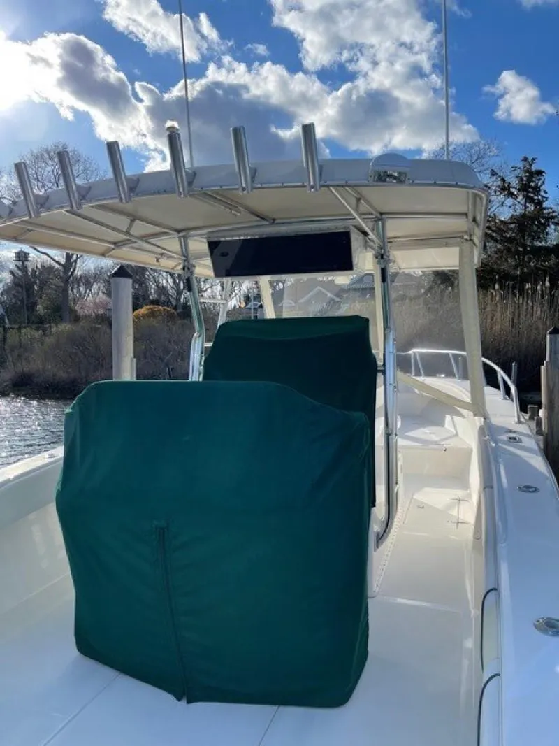 Slide: The Image of 2000 Venture 34 Center Console boat with green seat covers, under a blue sky. - 8