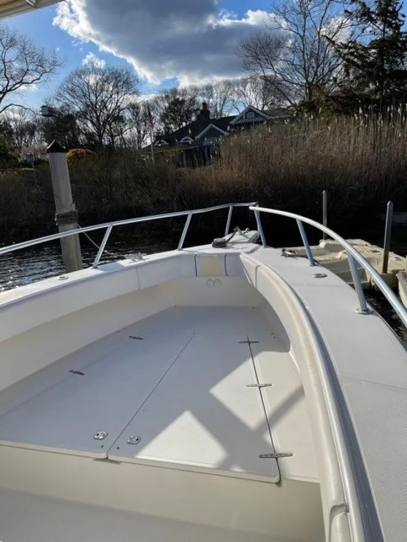 Slide: The Image of 2000 Venture 34 Center Console boat docked near reeds under a cloudy sky. - 9