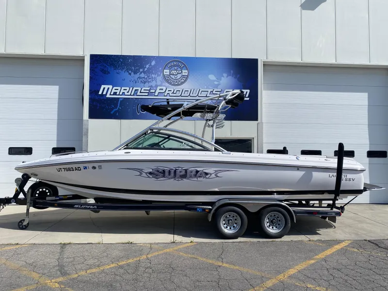 Slide: The Image of 2006 Supra Launch 24 SSV boat on trailer outside Marine Products store. - 1