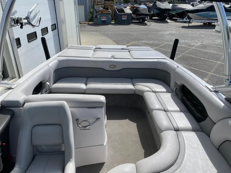 Slide: The Image of 2006 Supra Launch 24 SSV boat interior with gray seating and open deck. - 10