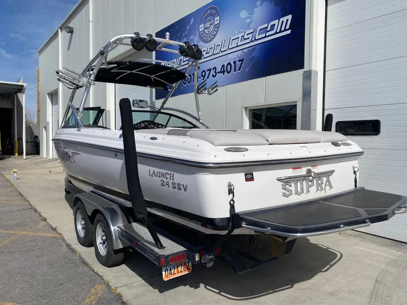 Slide: The Image of 2006 Supra Launch 24 SSV boat on trailer outside a building. - 4