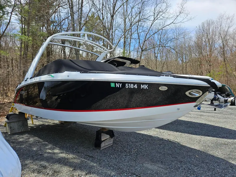 Slide: The Image of 2015 Cobalt R3 boat on trailer, black and white design, parked outdoors. - 0