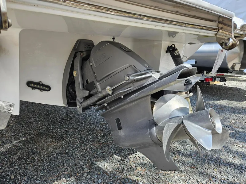 Slide: The Image of 2015 Cobalt R3 boat propeller and outdrive on gravel surface. - 2