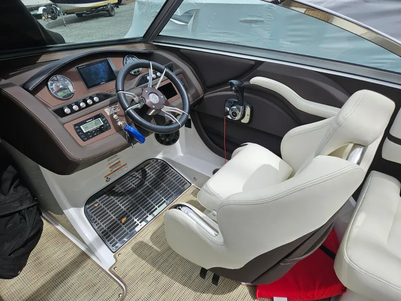 Slide: The Image of Interior of a 2015 Cobalt R3 boat featuring a sleek dashboard and comfortable seating. - 6
