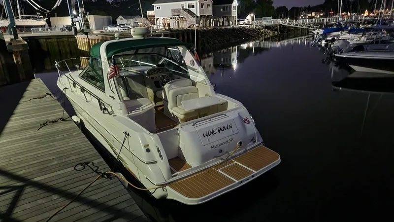 Slide: The Image of 1999 Sea Ray 290 Sundancer docked at marina during evening. - 5