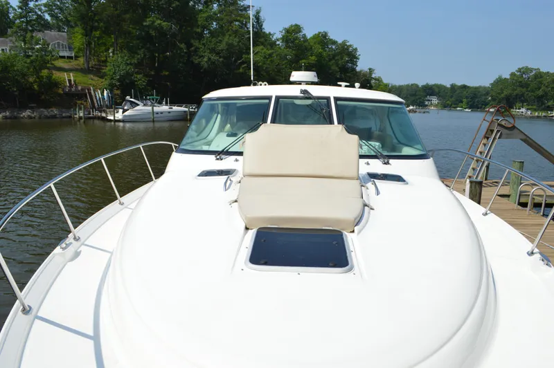 Slide: The Image of 2006 Tiara Yachts 4300 Sovran on a serene river dock. - 10