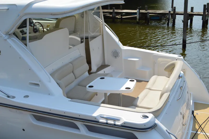 Slide: The Image of 2006 Tiara Yachts 4300 Sovran with spacious seating and table on deck. - 15