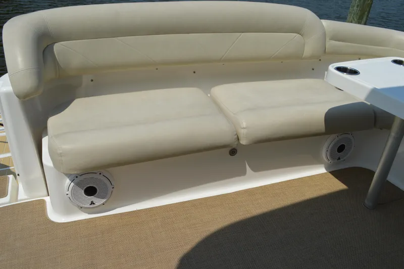 Slide: The Image of 2006 Tiara Yachts 4300 Sovran seating area with beige cushions and built-in speakers. - 18