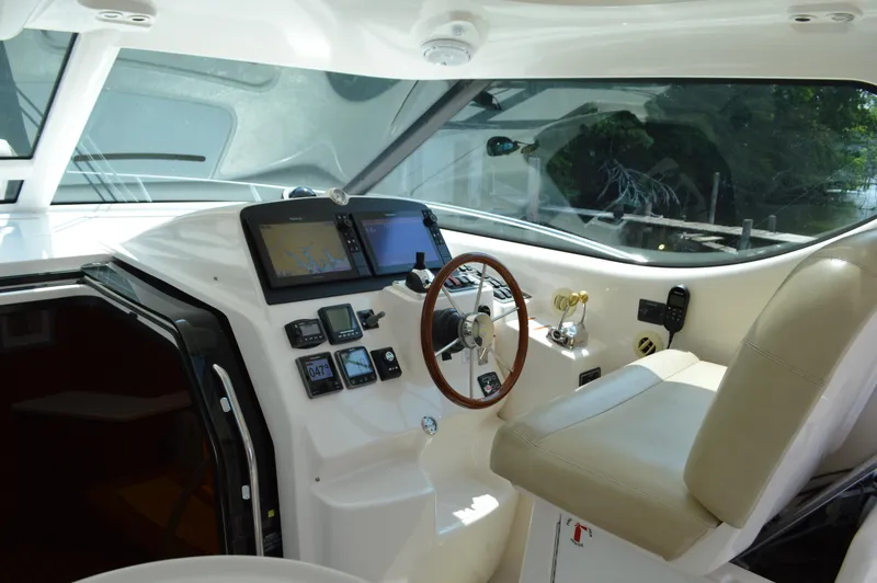 Slide: The Image of 2006 Tiara Yachts 4300 Sovran helm with modern navigation equipment and comfortable seating. - 27