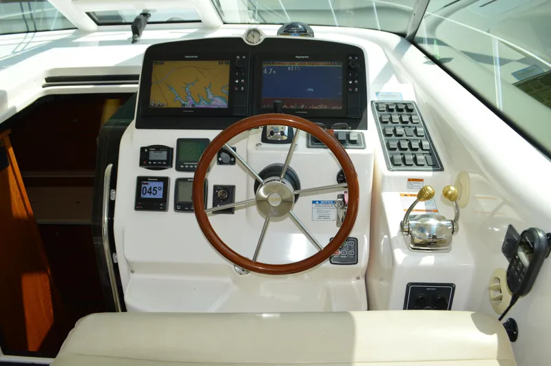 Slide: The Image of 2006 Tiara Yachts 4300 Sovran helm with navigation screens and controls. - 28