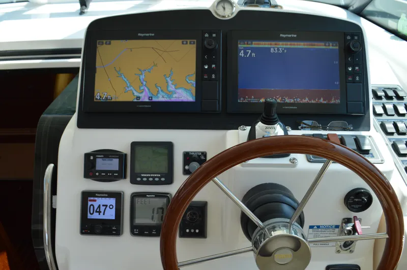 Slide: The Image of 2006 Tiara Yachts 4300 Sovran helm with navigation screens and controls. - 29