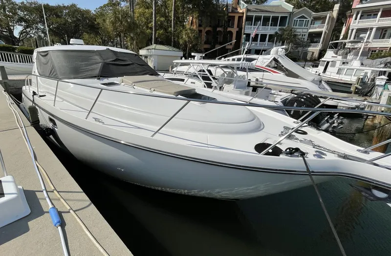 Slide: The Image of 2006 Tiara Yachts 4300 Sovran docked at a marina with surrounding boats. - 3