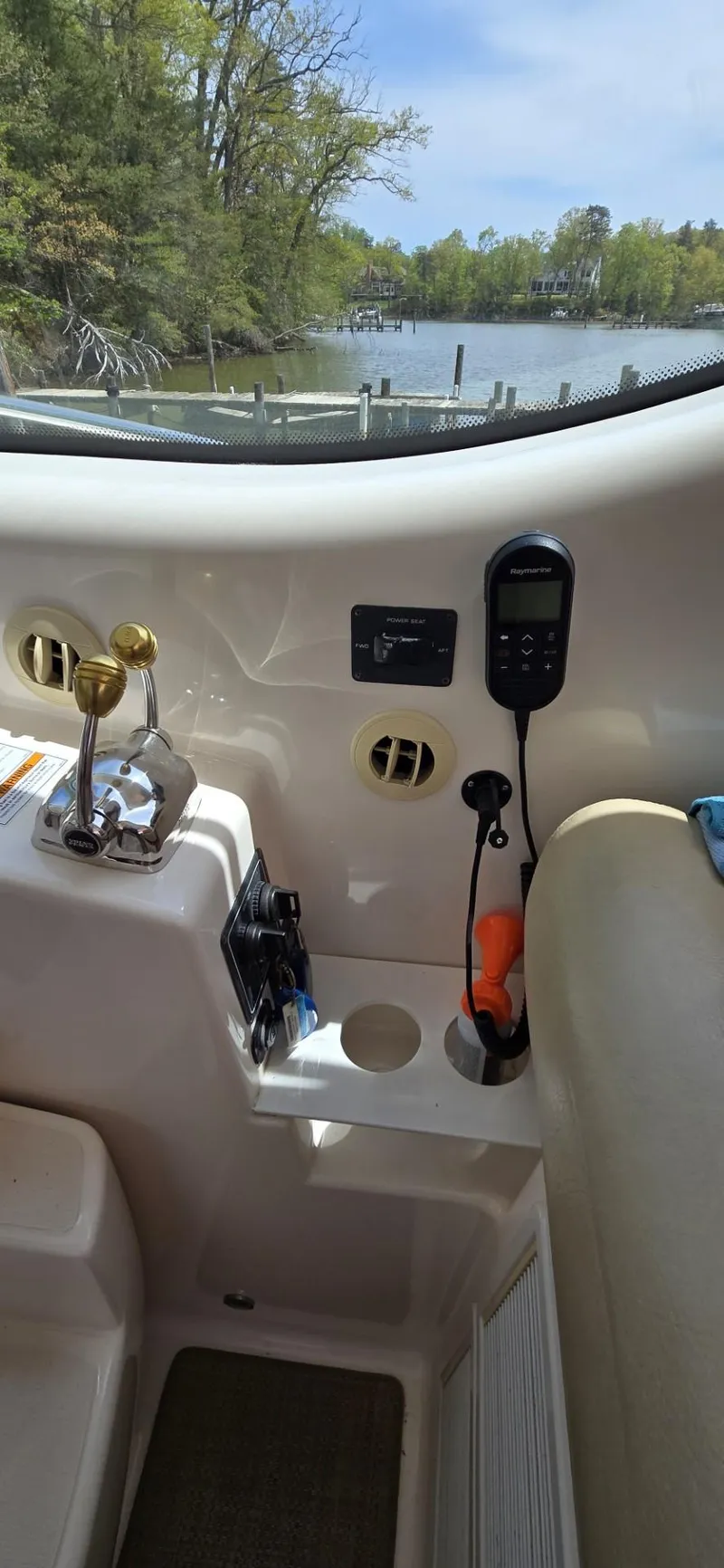 Slide: The Image of 2006 Tiara Yachts 4300 Sovran helm with controls and scenic waterway view. - 32