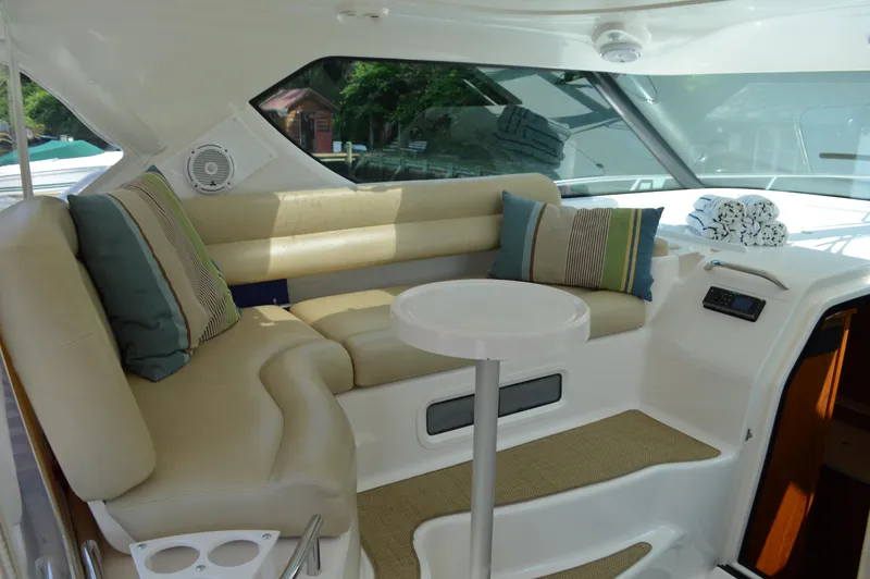 Slide: The Image of 2006 Tiara Yachts 4300 Sovran interior with beige seating and striped cushions. - 37