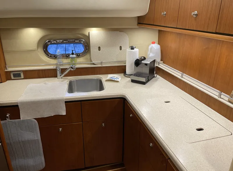 Slide: The Image of 2006 Tiara Yachts 4300 Sovran kitchen with wooden cabinets and modern appliances. - 59