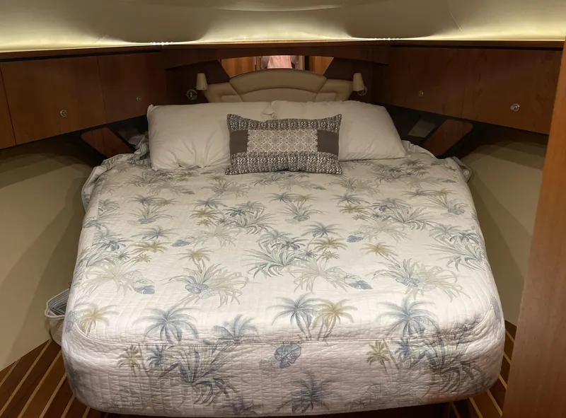 Slide: The Image of 2006 Tiara Yachts 4300 Sovran cabin with a cozy bed and tropical-themed bedding. - 70