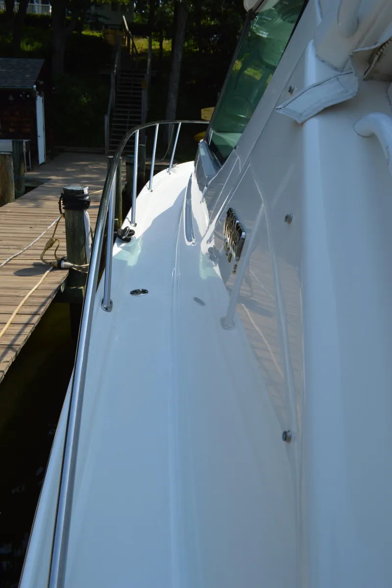 Slide: The Image of 2006 Tiara Yachts 4300 Sovran docked, showcasing sleek white exterior and railing. - 9