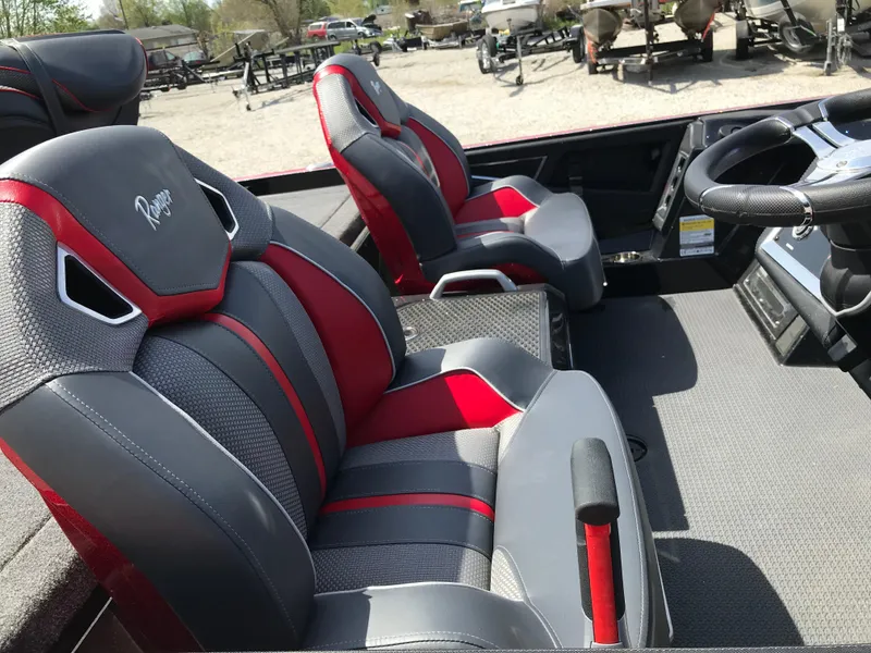 Slide: The Image of 2023 Ranger Z520R boat interior with red and gray seats, steering wheel visible. - 11