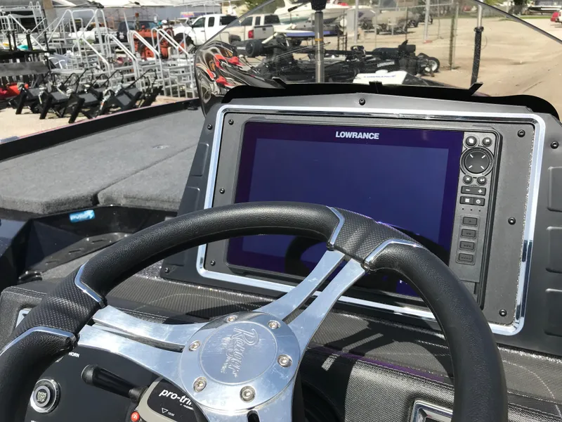 Slide: The Image of 2023 Ranger Z520R boat dashboard with Lowrance display and steering wheel. - 12