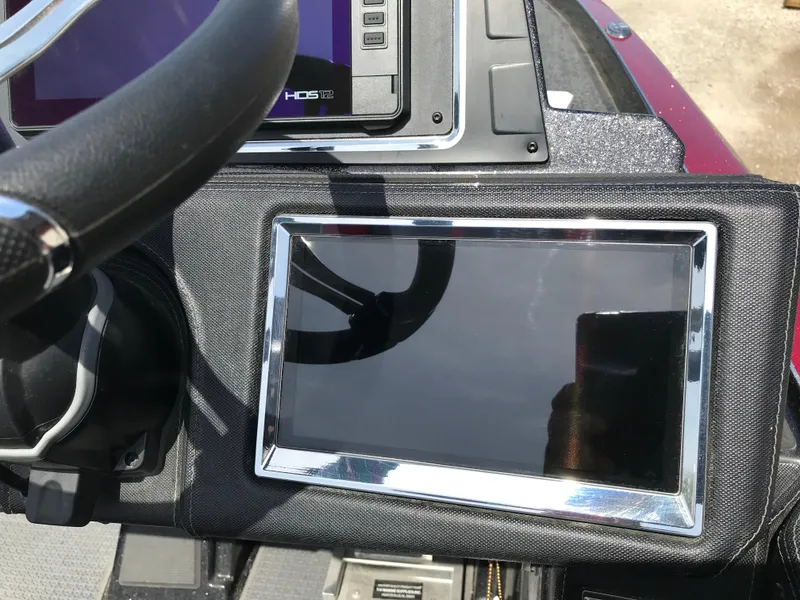 Slide: The Image of 2023 Ranger Z520R boat dashboard with modern navigation display and steering wheel. - 13