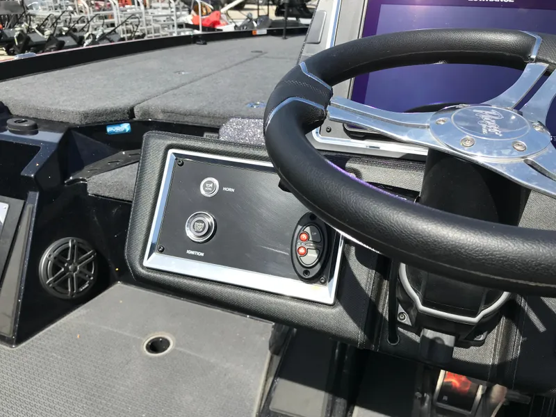 Slide: The Image of 2023 Ranger Z520R boat dashboard with steering wheel and control panel. - 14