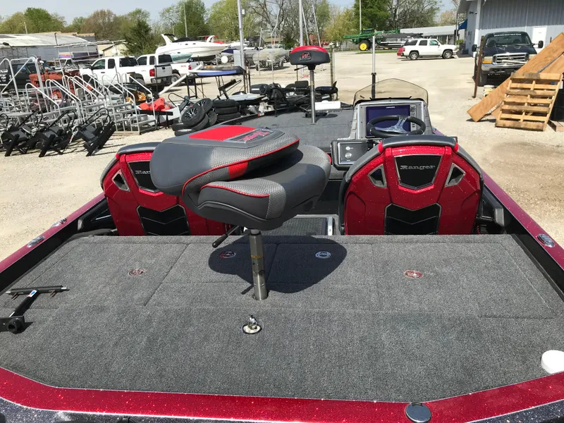 Slide: The Image of 2023 Ranger Z520R Ranger Cup Equipped boat with red and black seating, parked outdoors. - 18