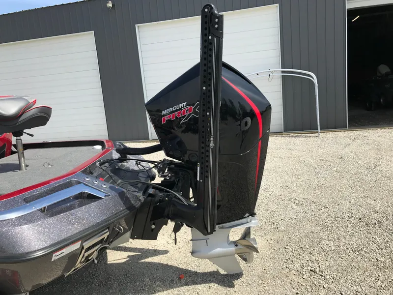 Slide: The Image of 2023 Ranger Z520R boat with Mercury Pro XS engine, parked on gravel near garage doors. - 21