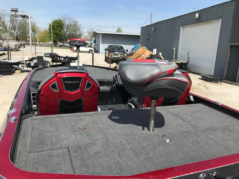 Slide: The Image of 2023 Ranger Z520R boat with red accents and seating, parked outdoors. - 22