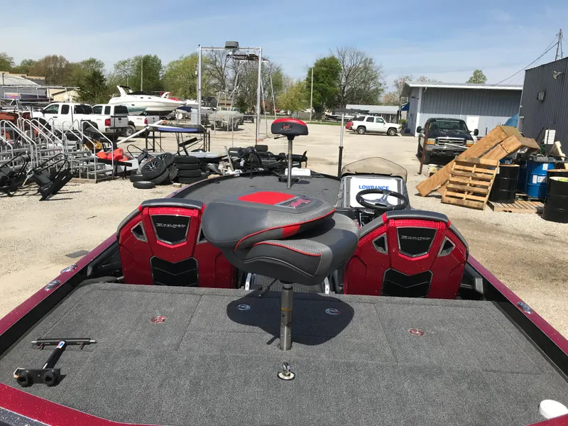 Slide: The Image of 2023 Ranger Z520R Ranger Cup Equipped boat with red and black seating, parked outdoors. - 27