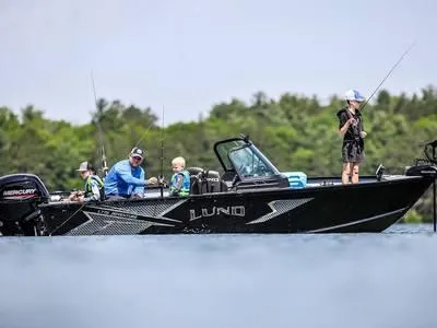 Slide: The Image of 2025 Lund 1775 Adventure Sport boat with people fishing on a calm lake. - 1