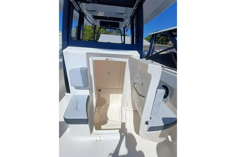 Slide: The Image of 2025 Robalo R300 Center Console boat interior with open storage compartment. - 16