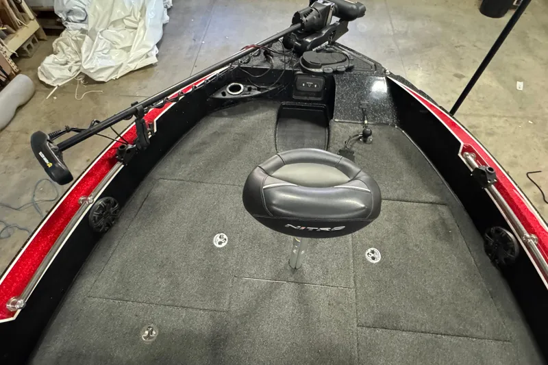Slide: The Image of 2022 Nitro ZV20 boat interior with gray seating and fishing equipment. - 15
