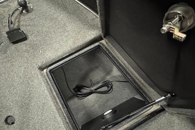 Slide: The Image of Interior storage compartment of 2022 Nitro ZV20 boat with coiled cable. - 18