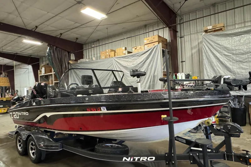 Slide: The Image of 2022 Nitro ZV20 boat in a warehouse, featuring a sleek red and black design. - 2
