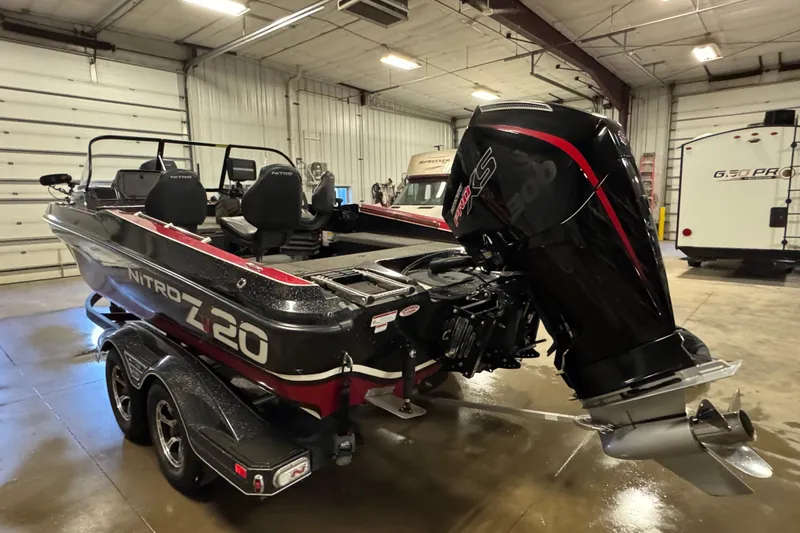 Slide: The Image of 2022 Nitro ZV20 boat with powerful outboard motor in a spacious indoor garage. - 4