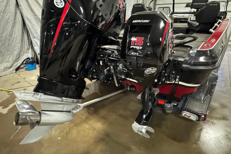 Slide: The Image of 2022 Nitro ZV20 boat with Mercury 15 Pro outboard motor in a garage setting. - 5