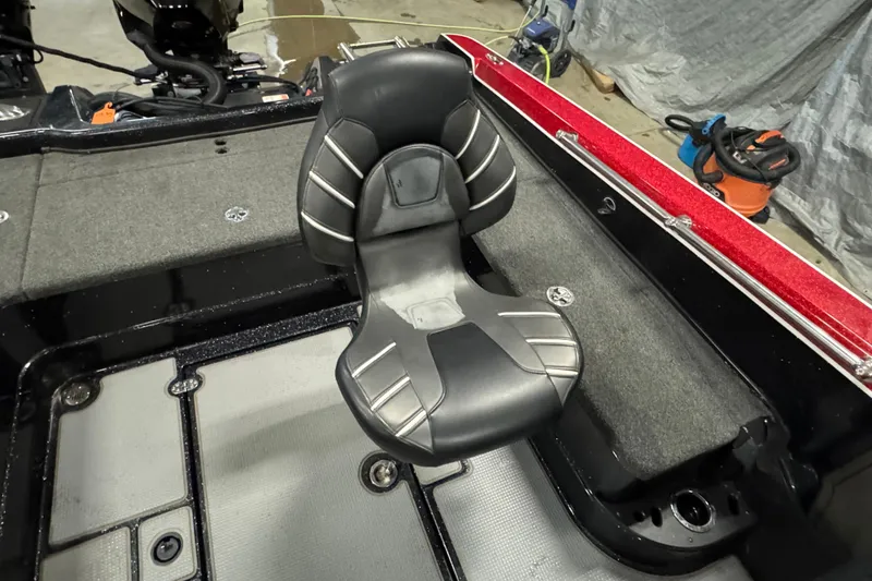 Slide: The Image of 2022 Nitro ZV20 boat interior with black and gray seat, red trim, and carpeted flooring. - 7