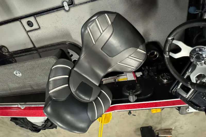 Slide: The Image of Interior of a 2022 Nitro ZV20 boat featuring sleek black seats and steering wheel. - 9