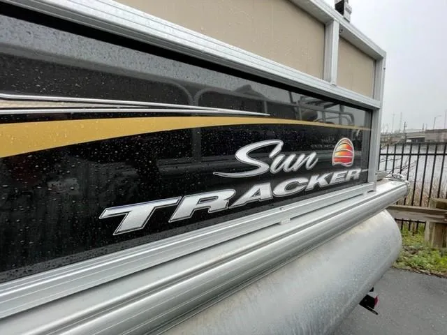 Slide: The Image of 2022 Sun Tracker Bass Buggy 16 XL Select pontoon boat with logo detail. - 2