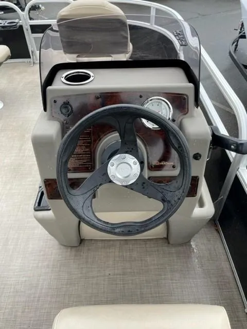 Slide: The Image of 2022 Sun Tracker Bass Buggy 16 XL Select boat console with steering wheel and gauges. - 6