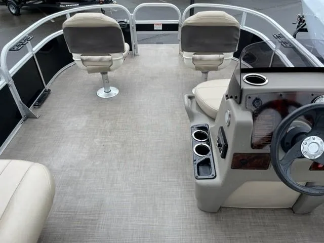 Slide: The Image of 2022 Sun Tracker Bass Buggy 16 XL Select pontoon boat interior with seating and steering console. - 7