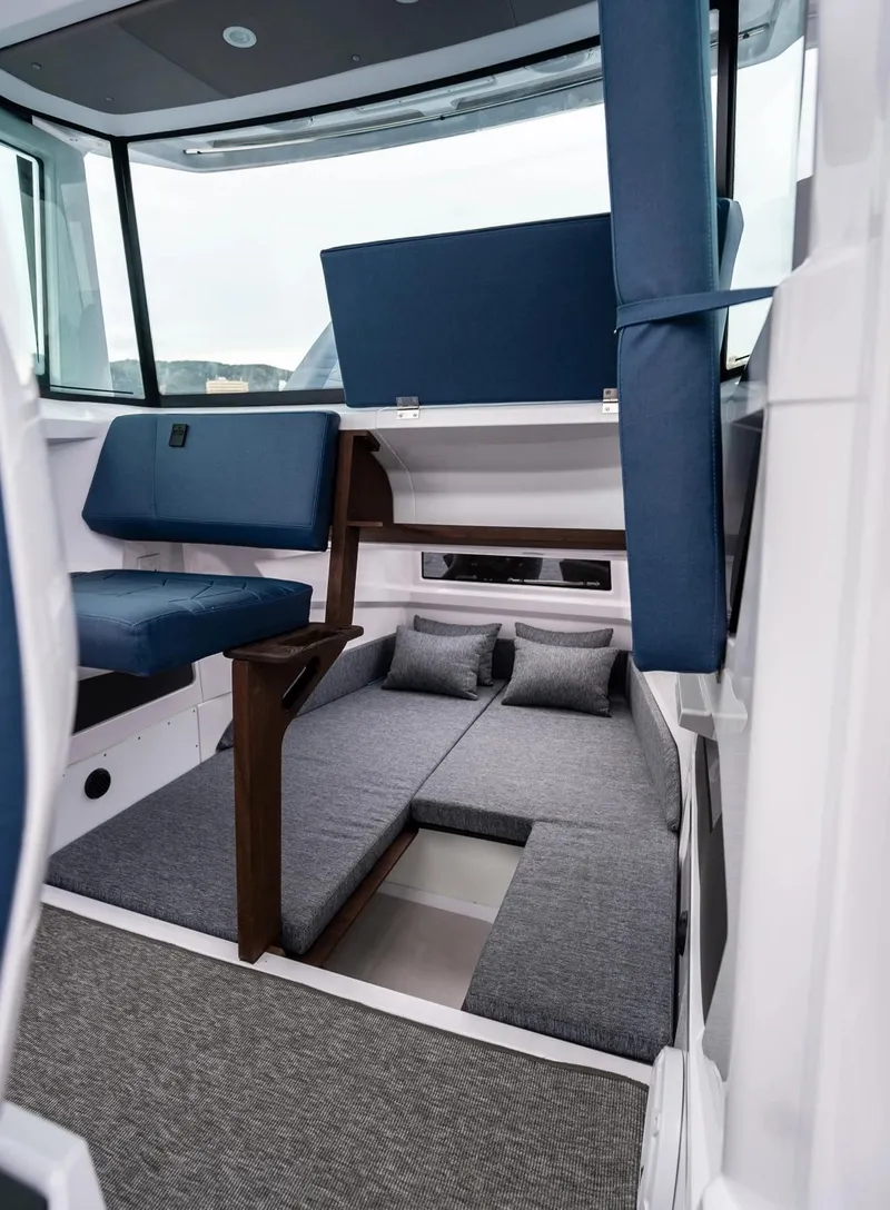 Slide: The Image of 2026 Axopar 29 XC Cross Cabin interior with modern helm and comfortable seating. - 11