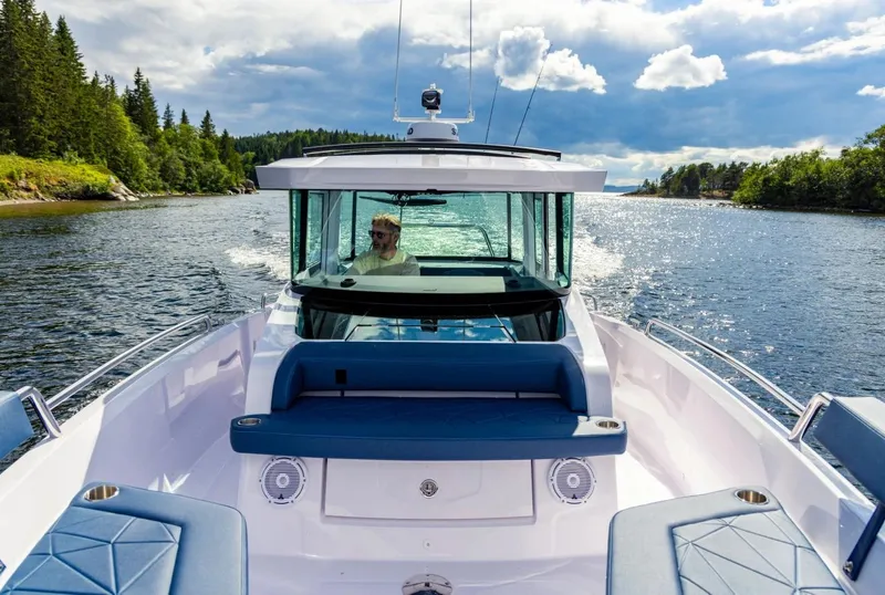 Slide: The Image of 2026 Axopar 29 XC Cross Cabin with spacious cushioned seating and modern design. - 13