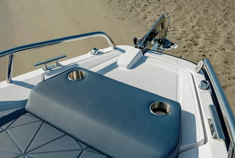 Slide: The Image of 2026 Axopar 29 XC Cross Cabin interior with cushioned seating and wooden cabinetry. - 19