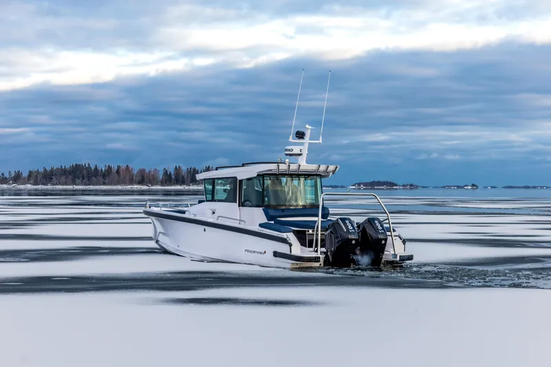 Slide: The Image of 2026 Axopar 29 XC Cross Cabin boat interior with cushioned seating and modern design. - 2